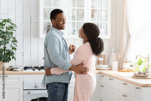 Couple's Domestic Life. Loving Black Spouses Dancing In Cozy Kitchen At Home