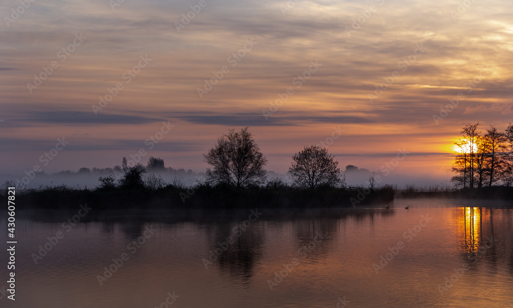 Orange Sunrise with reflections on the water Orange Sunrise with reflections on the water