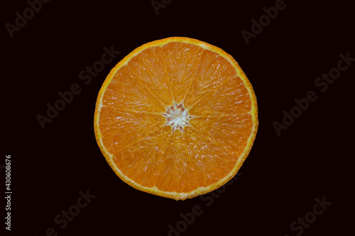 Orange cut in half on black background