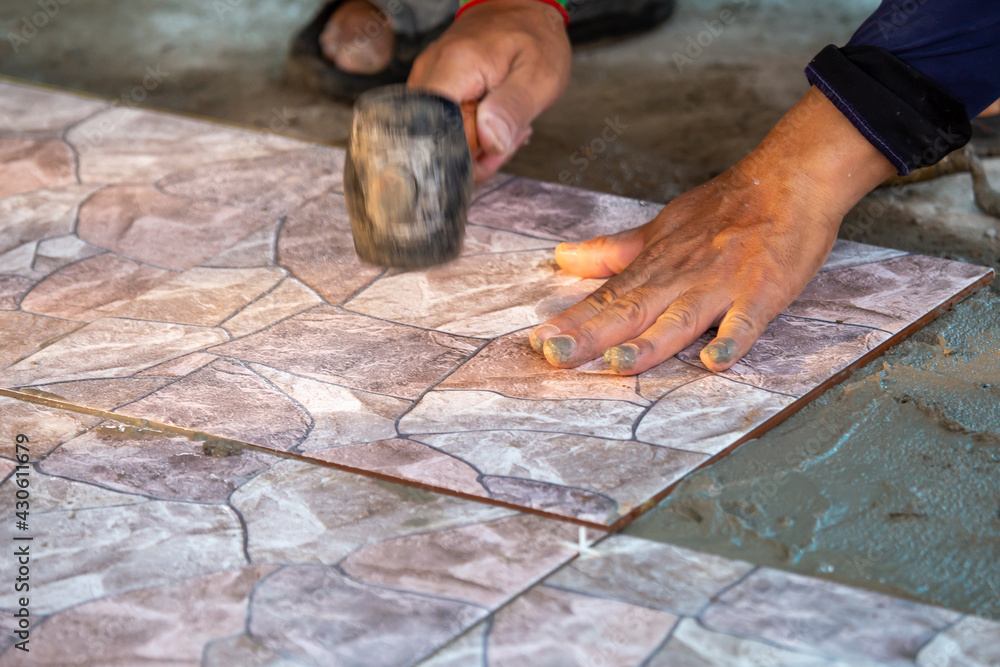 New close-up floor tiles are about to be built by skilled craftsmen. Must be arranged to be level New close-up floor tiles are about to be built by skilled craftsmen. Must be arranged to be level