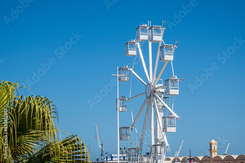 Ferris wheel installed on the beach of Gandia, with the blue sky in the background. photo