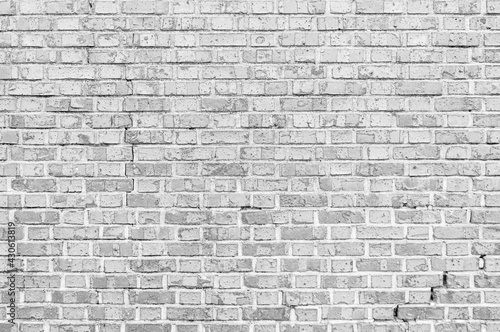 Broken, cracked white brick wall background.