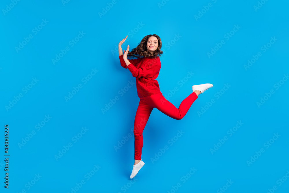 Full length body size photo of woman wearing casual outfit jumping high isolated on vibrant blue color background