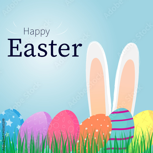 Easter bunny ears with easter eggs on meadow with blue background