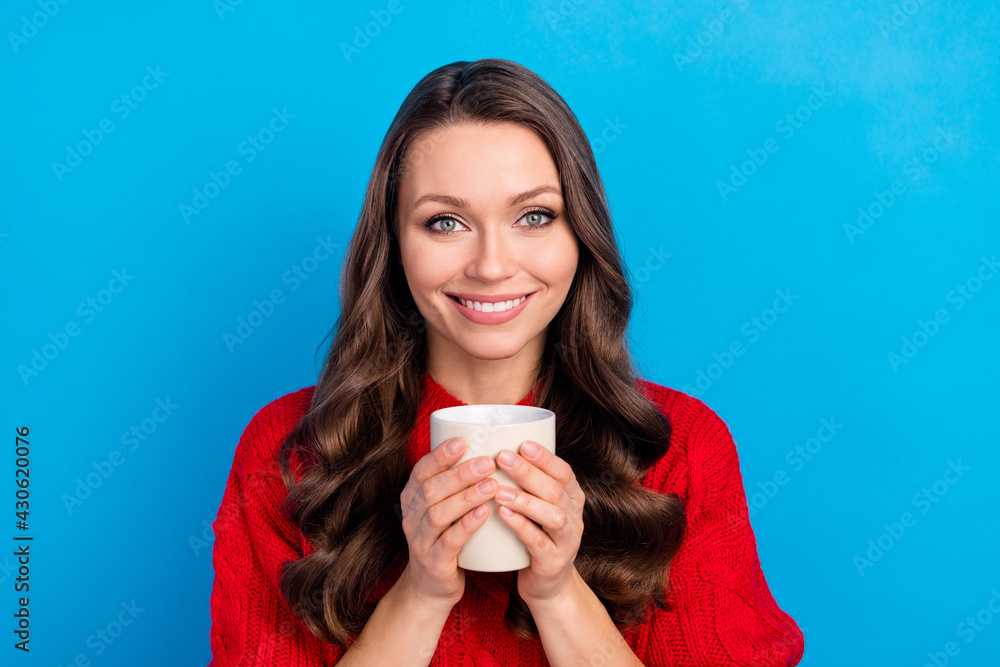 Photo portrait of pretty girl drinking coffee smiling isolated on bright blue color background Photo portrait of pretty girl drinking coffee smiling isolated on bright blue color background