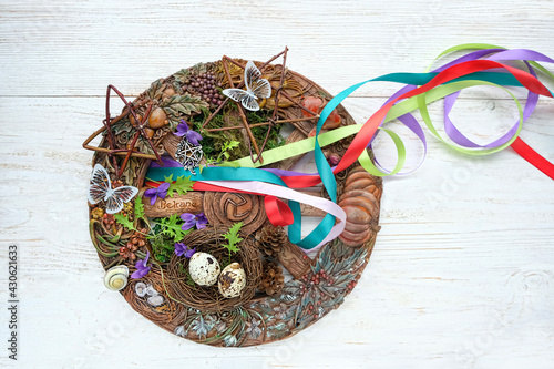 Wiccan altar for Beltane sabbath. spring pagan festive ritual. wheel of the year with colorful ribbons, flowers, pentagram - symbol of Beltane celtic holiday, spring season. 30 april -1 may date. photo