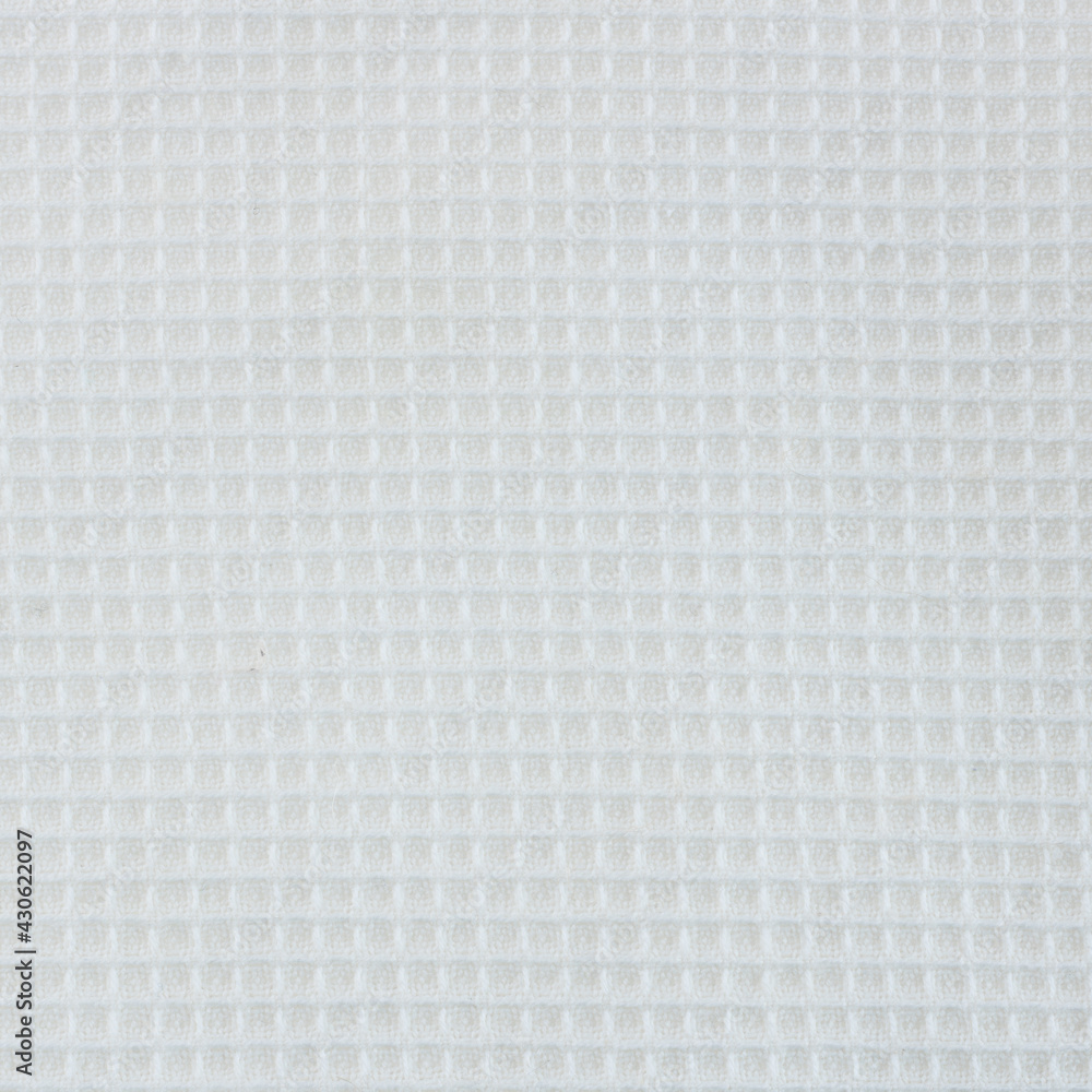 Close-up of the texture of a white cotton fabric in a cage.