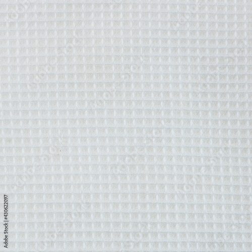 Close-up of the texture of a white cotton fabric in a cage.