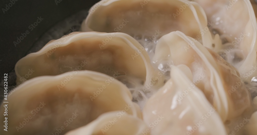 Grilling japanese dumpling on fry pan