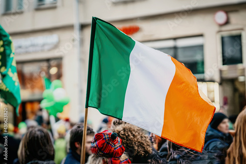 Canvastavla National Flag of Ireland close-up in hands of girl in national beret hat in city street, celebration of St