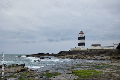 big waves hitting stones at hook lighthouse. Wexford, Ireland