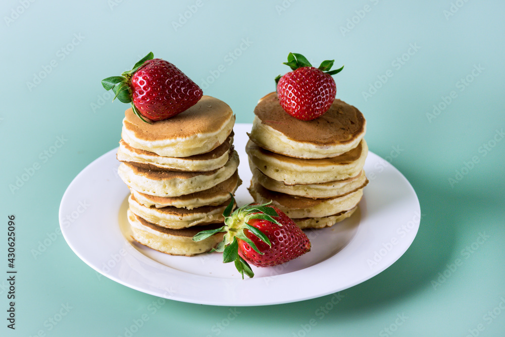 Freshly Baked Homemade Mini Pancakes on a Plate Fresh Berry Tasty Breakfast Green Background Horizontal