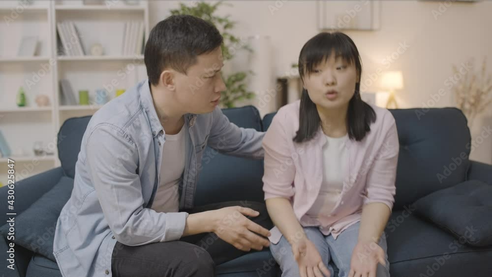 Asian man comforting upset wife, support in couple, overcoming crisis together Asian man comforting upset wife, support in couple, overcoming crisis together