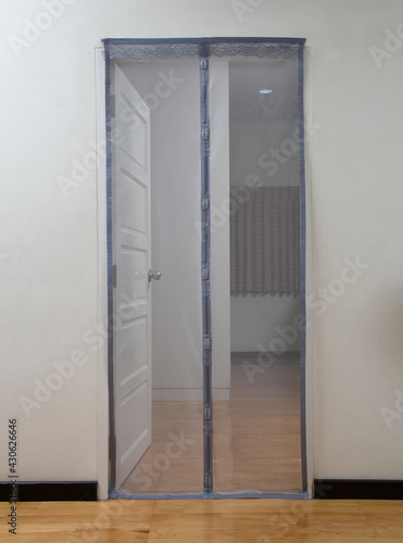 bedroom door with cloth mosquito net  for protect you from mosquito or insect © venusangel