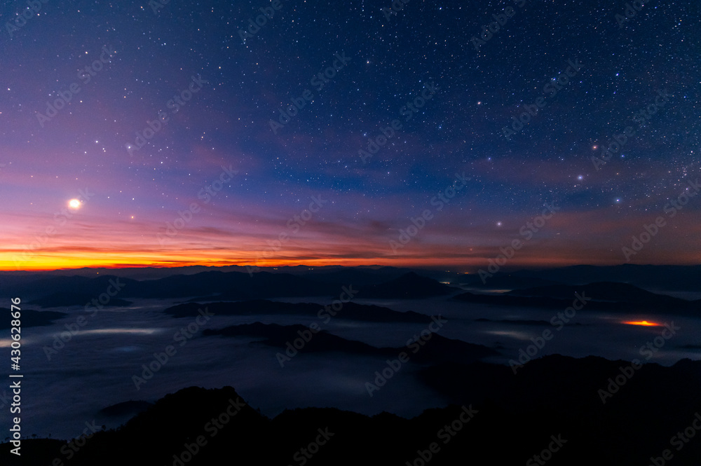 Landscape and starscape of the mountain and sea of mist in winter sunrise view from top of Phu Chi Dao mountain , Chiang Rai, Thailand