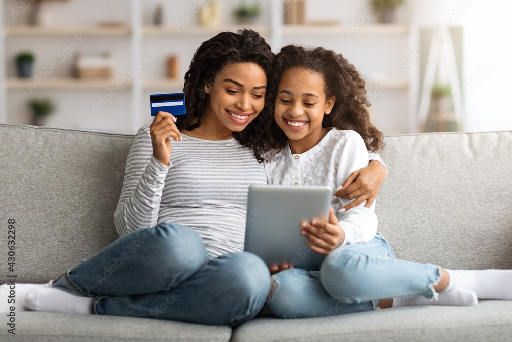 Cute african american mother and kid shopping on tablet Cute african american mother and kid shopping on tablet