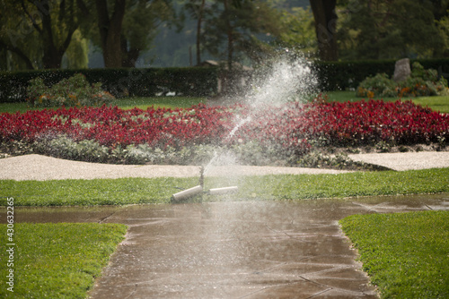 irrigation or park sprinkler system with a wide coverage over a unique garden bed 