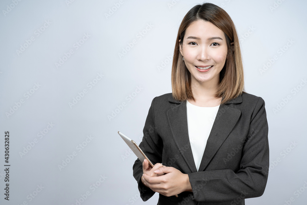 Beautiful Asian businesswoman in a black suit, isolated on a white background. Beautiful Asian businesswoman in a black suit, isolated on a white background.