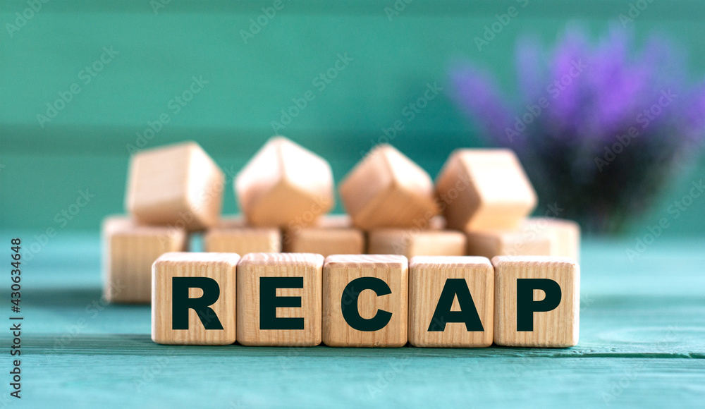 RECAP - word on wooden cubes on a green background with lavender RECAP - word on wooden cubes on a green background with lavender