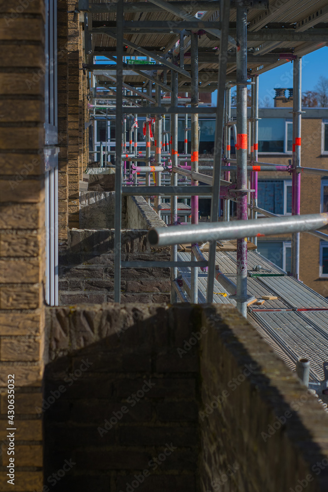 Scaffolding used as a temporary structure to support the building structure and a work platform for employees Scaffolding used as a temporary structure to support the building structure and a work platform for employees