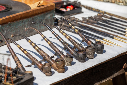 Photography Handmade decorative smoking pipes for opium and other souvenir in a tourist stal