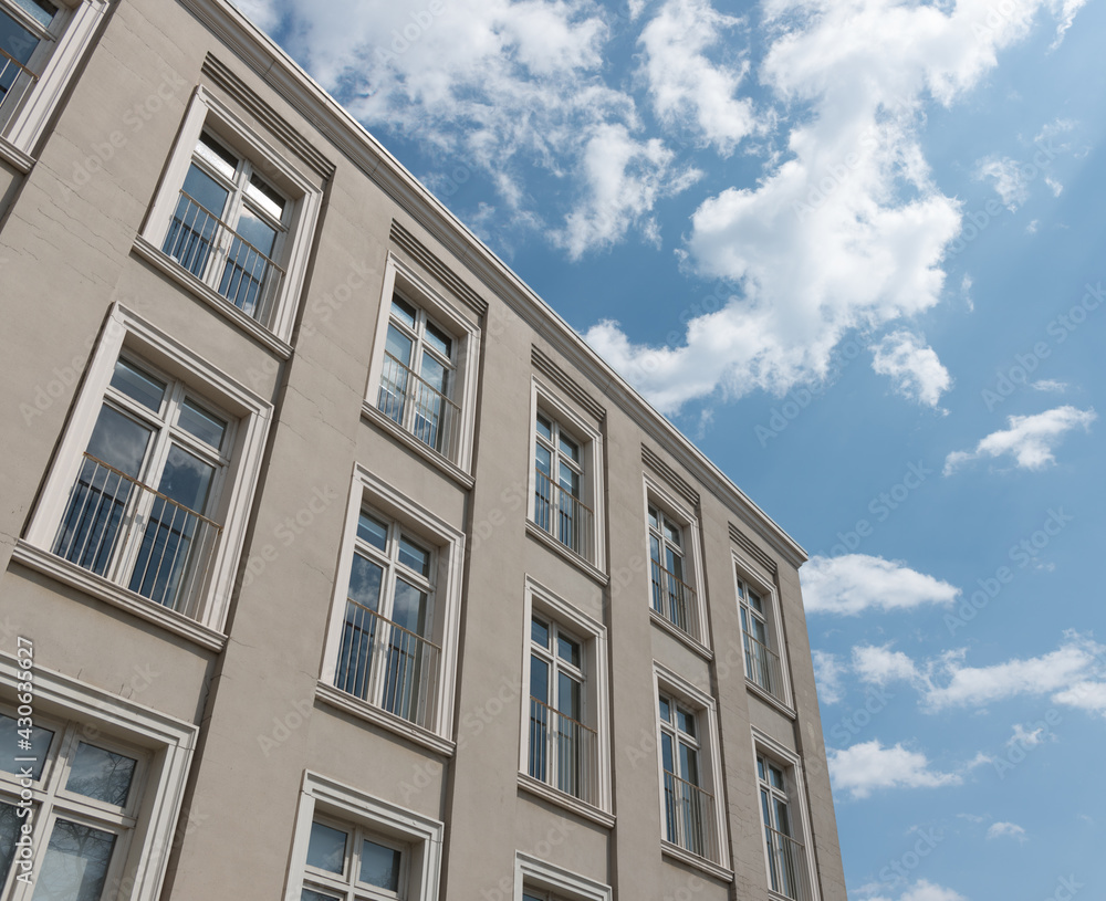 former manufacturing building now converted to office spaces with cloudy blue sky