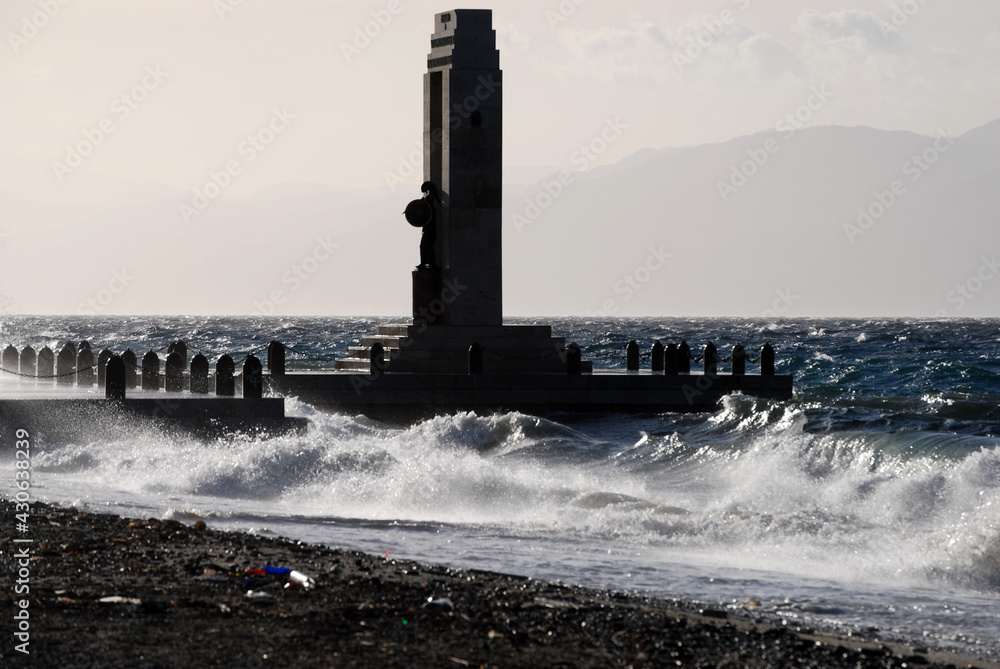 Litter, beach, statue and the storm at sea. Reggio Calabria, winter 2010.