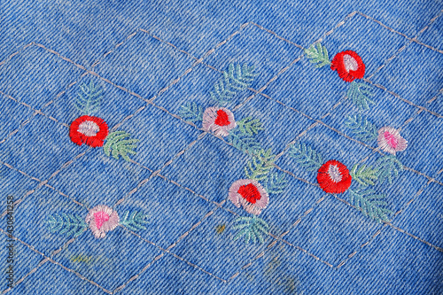 Hand craff flowers on jean cloth texture background. photo