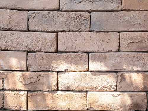 The walls are made of brown-red bricks. With patterns and texture