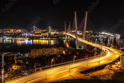 Top view of the night Vladivostok with the Golden Horn bridge and the bridge Russian. Far East, Russia