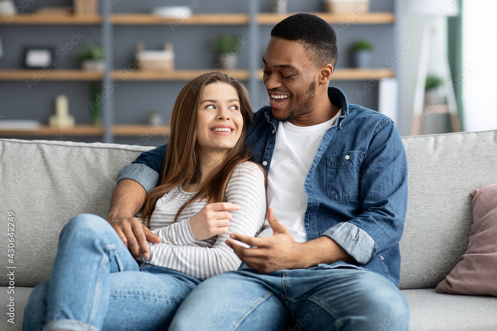 Domestic Leisure. Romantic Interracial Couple Relaxing At Home Together Domestic Leisure. Romantic Interracial Couple Relaxing At Home Together