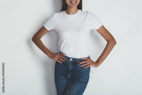 Cropped portrait of young woman in jeans and blank white t-shirt