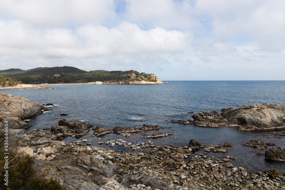 Landscape of the coastline of the mediterranean sea in Spain. big rocks in front