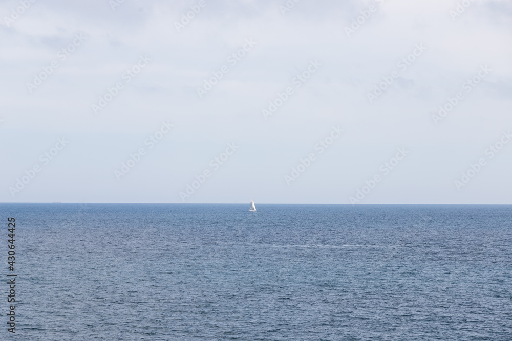 Small white boat in the middle of the sea. Landscape of the mediterranean sea