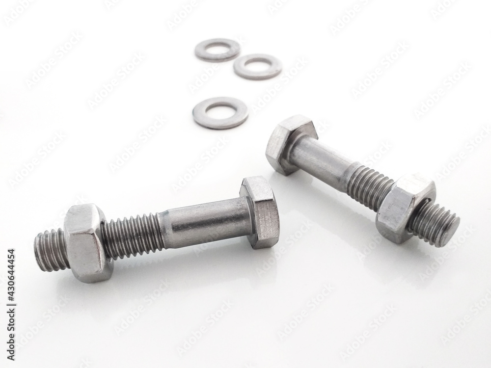 Aerial view of bolts with nut and metal washers in horizontal position isolated on white background. Close up of Piece of hardware store. DIY utensils and tools. Aerial view of bolts with nut and metal washers in horizontal position isolated on white background. Close up of Piece of hardware store. DIY utensils and tools.