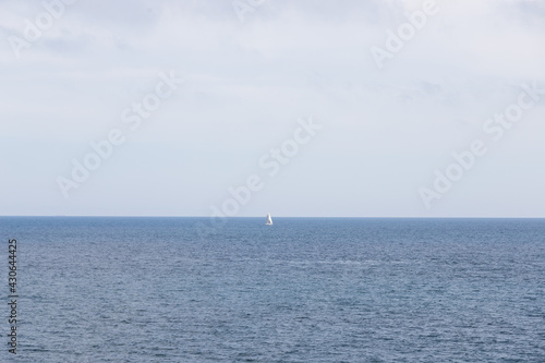 Small white boat in the middle of the sea. Landscape of the mediterranean sea