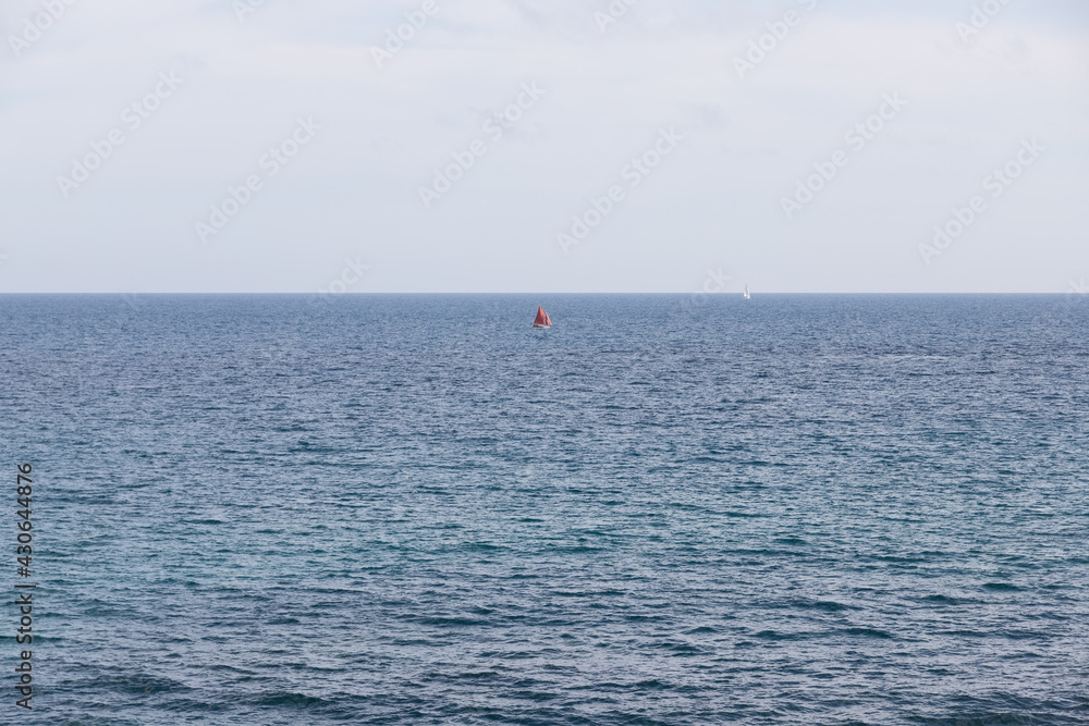 Small red boat in the middle of the sea. Landscape of the mediterranean sea