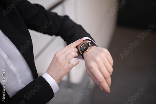 Caucasian girl looks at her watch. Close-up