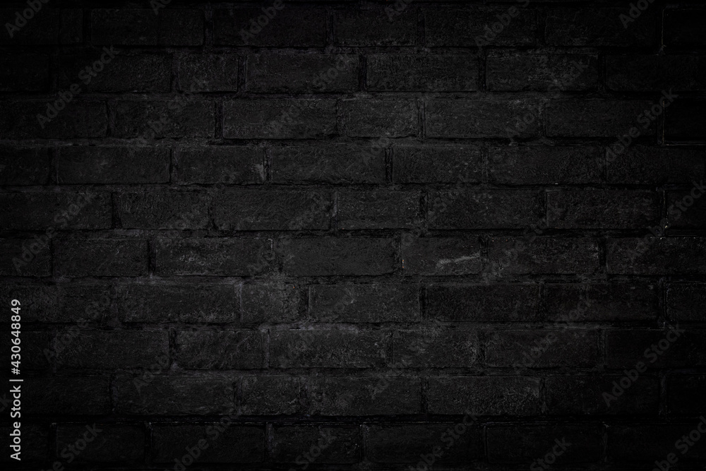 Dark Black color old grunge look brick wall textured background with vignette at the edge of picture.