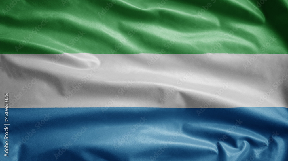 Sierra Leone flag waving in the wind. Close up Salone banner blowing soft silk