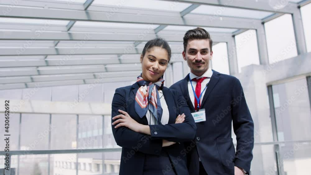 Front view of young stewards in airport, looking at camera. Front view of young stewards in airport, looking at camera.