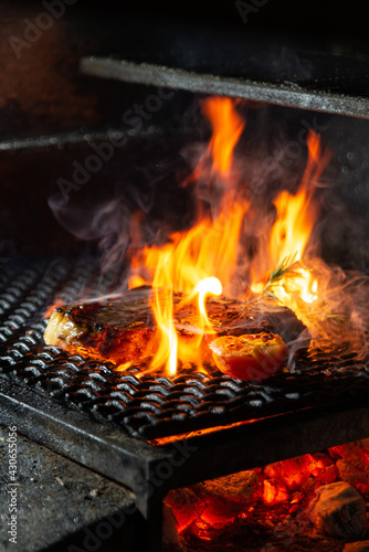 grilled meat on a grill with fire 