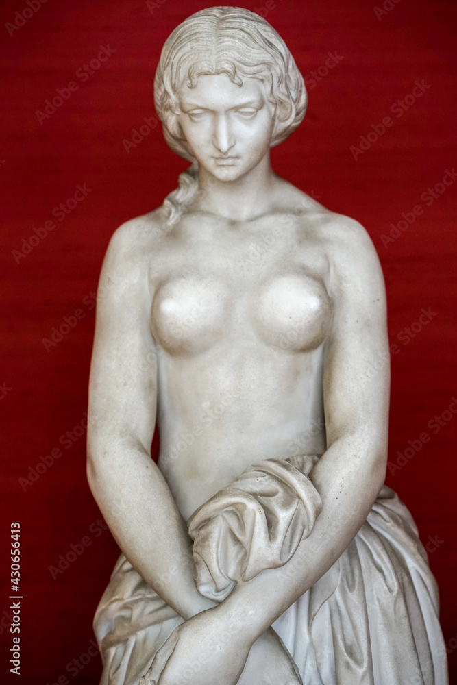 Fototapeta premium white stone sculpture of women showing breasts 
