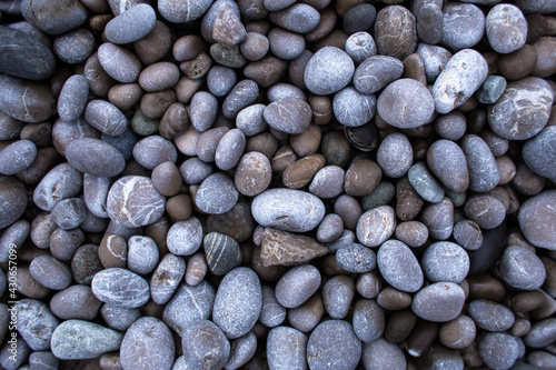 Small round pebbles on the seashore.