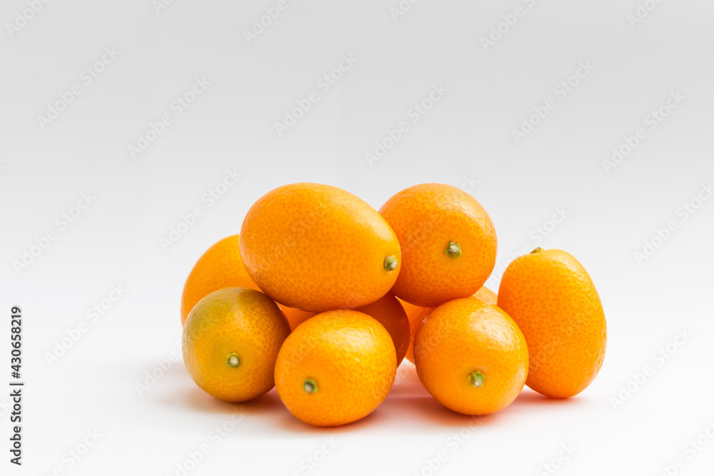 kumquat on white background. exotic fruits kumquat on white background. exotic fruits