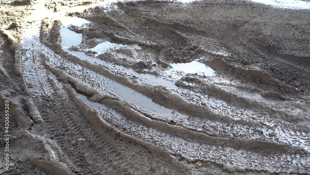 Car tracks on wet ground. Close-up of dirt. Car tracks on wet ground. Close-up of dirt.