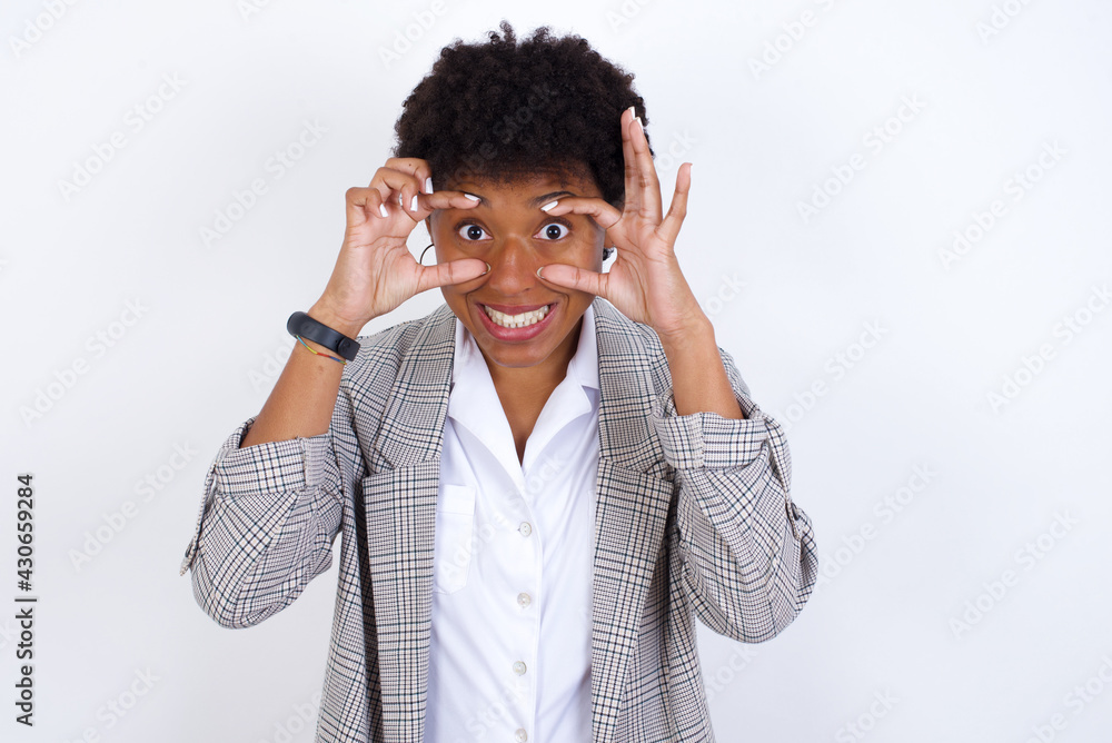 African American businesswoman with curly bushy hair wears formal clothes over white background keeping eyes opened to find a success opportunity. African American businesswoman with curly bushy hair wears formal clothes over white background keeping eyes opened to find a success opportunity.