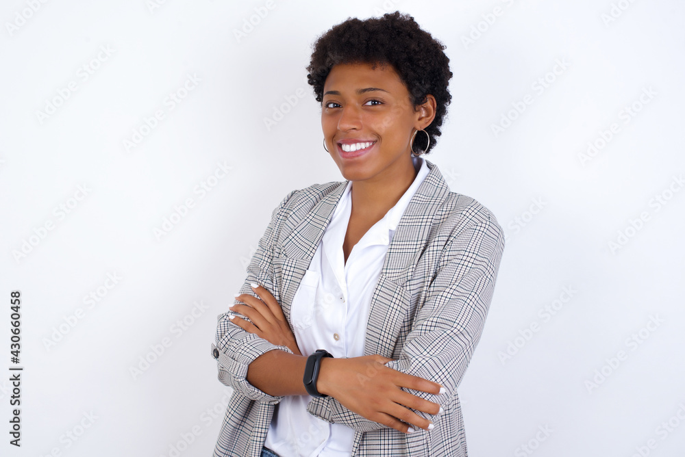 Εκτύπωση καμβά African American businesswoman with curly bushy hair wears  formal clothes over white background happy face smiling with crossed arms looking at the camera