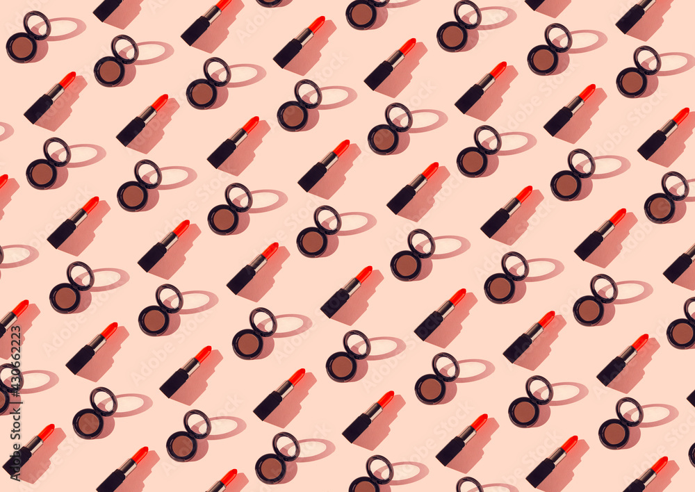 Creative pattern made of red lipsticks and eyeshadows on pastel background. Cosmetic and makeup concept. Beauty and fashion theme. Top view. Flat lay Creative pattern made of red lipsticks and eyeshadows on pastel background. Cosmetic and makeup concept. Beauty and fashion theme. Top view. Flat lay