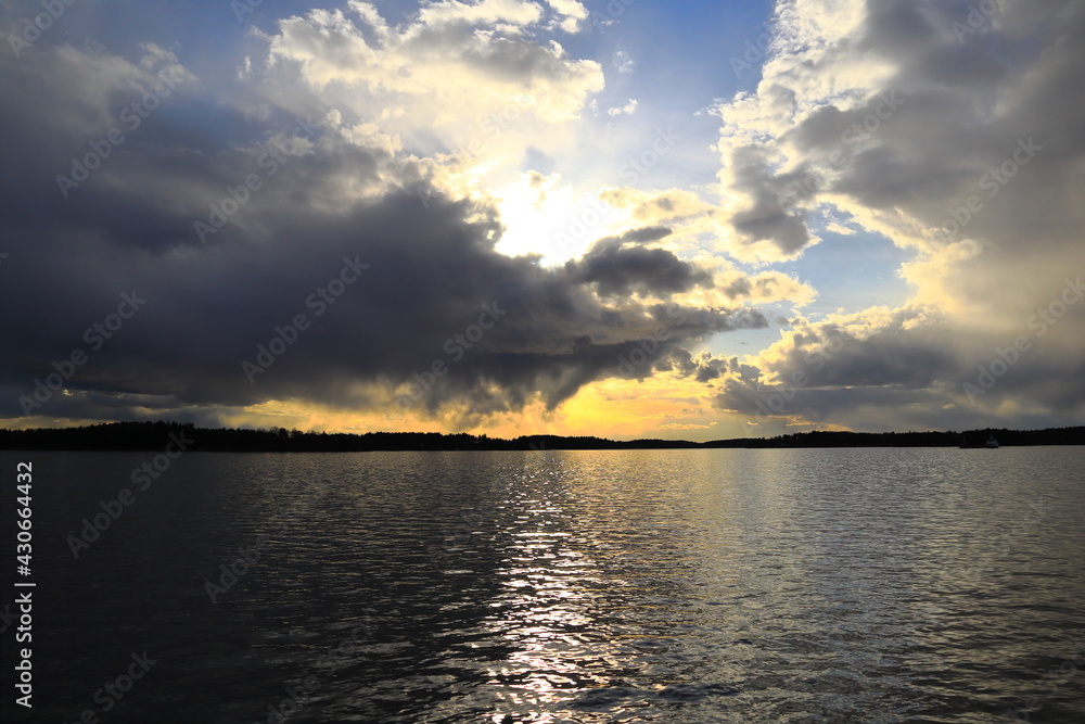 Beautiful sunset at the Swedish lake Mälaren or Malaren. Spring weather with plenty of clouds. Nice and calm view. Järfälla, Stockholm, Sweden, Europe. Beautiful sunset at the Swedish lake Mälaren or Malaren. Spring weather with plenty of clouds. Nice and calm view. Järfälla, Stockholm, Sweden, Europe.